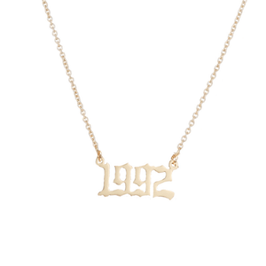 Gold '1992' necklace on a white background
