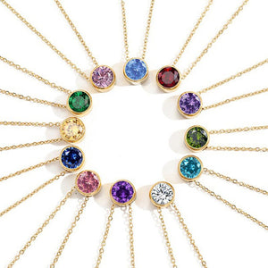 Gold necklaces with colorful gemstones on a white background