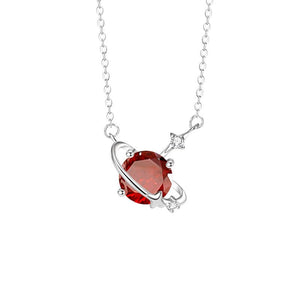 Silver necklace with a red gemstone pendant on a white background