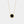 Gold plated round locket necklace featuring a black agate stone center with a halo of small clear stones, on a delicate chain against a white background.