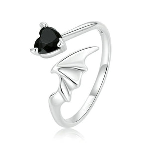 Silver ring with a black gemstone on a white background