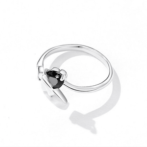 Silver ring with a black gemstone on a white background