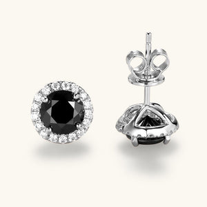 Pair of black gemstone earrings with silver settings on a white background