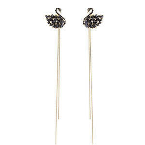 Pair of Swan-shaped earrings on a white background