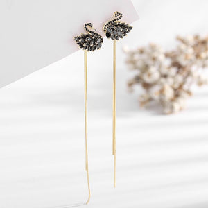Long earrings with decorative elements on a white background