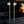 Pink swan earrings on a black stand with a blurred background