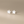Star-shaped earrings on a beige background