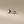 Star-shaped earrings on a beige background