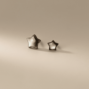 Star-shaped earrings on a beige background
