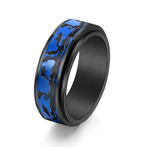 Black ring with blue and black pattern on a white background