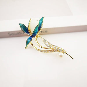 Decorative brooch with blue and gold design on a light background