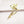 Gold dragonfly-shaped brooch on a white background