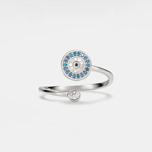 Silver evil eye spinner ring with blue gemstones on a white background