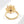 Gold evil eye flower spinner ring with a blue gemstone on a white background