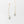 Gold leaf-shaped earrings on a light gray background