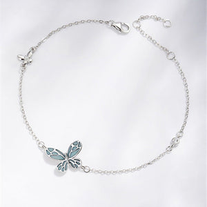 Silver bracelet with a butterfly charm on a white background