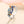 Silver ring with colorful gemstones on a light background