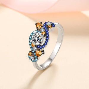 Silver ring with colorful gemstones on a light background