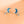 Pair of moon and star earrings with blue and silver design on a peach background