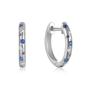 A pair of gold-plated sterling silver huggie earrings with diamond-cut zirconia stones, displayed against a white textured background.