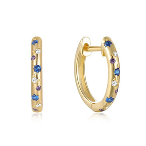 A pair of gold-plated sterling silver huggie earrings with diamond-cut zirconia stones, displayed against a white textured background.