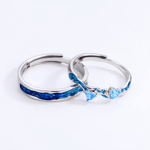 Two silver rings with blue gemstones on a white background