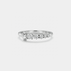 Silver star ring with small diamonds on a light gray background