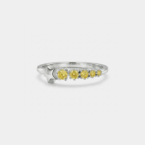 Silver star ring with yellow gemstones on a white background