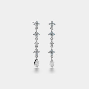 Pair of silver drop earrings on a light gray background