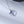 A couple of silver necklaces with blue star-shaped pendants and gold plating, displayed on a reflective surface.