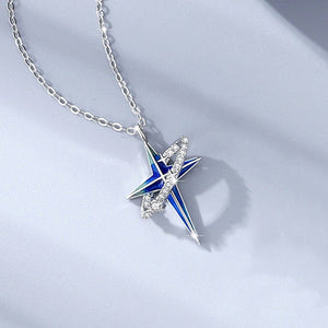 A couple of silver necklaces with blue star-shaped pendants and gold plating, displayed on a reflective surface.