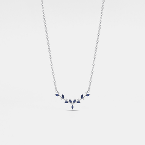 A gold-plated sterling silver necklace with a blue stone deer antler pendant.