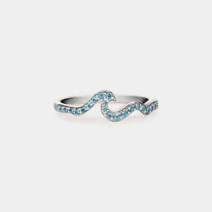 A gold-plated sterling silver ring with a wave-like design, embedded with blue cubic zirconia.