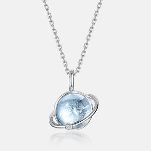 Silver necklace with a blue gemstone pendant on a white background