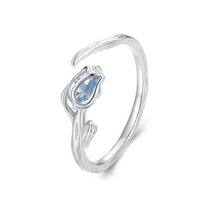 Silver ring with a blue gemstone on a white background