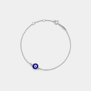 A gold-plated bracelet with a solid blue enamel charm on a white background