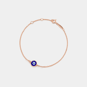 A gold-plated bracelet with a solid blue enamel charm on a white background