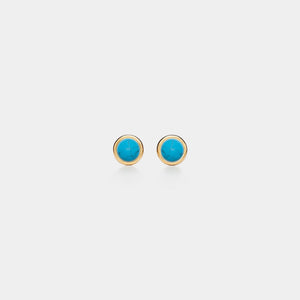 Pair of gold earrings with turquoise stones on a white background