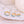 Gold hoop earrings with blue stones on a white shell