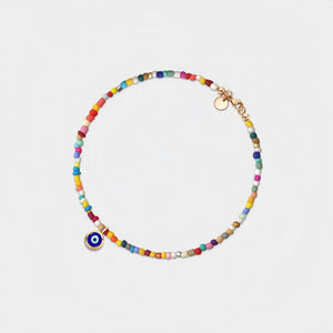 Multicolored beaded bracelet with a gold clasp on a light gray background