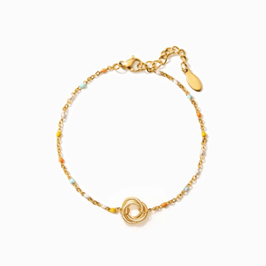 Gold bracelet with a circular design on a white background
