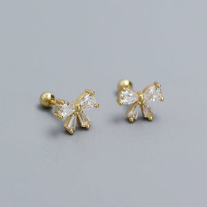 A set of bowknot screw back stud earrings in silver and gold colors.