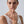 Woman wearing a silver ring on her finger against a plain background