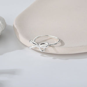 Two rings, one with a rose gold finish and the other with a silver finish, both featuring a bow knot design.