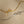 Gold and silver ribbons tied into bows on a beige background