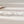 Silver bracelet with interlocking rings on a beige background