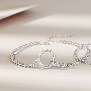 Two Mobius strip bracelets made of sterling silver, displayed on a white surface.