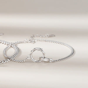 Two Mobius strip bracelets made of sterling silver, displayed on a white surface.