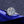 Diamond ring on a blue satin ribbon with a dark textured background