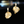 Gold floral earrings on a black background